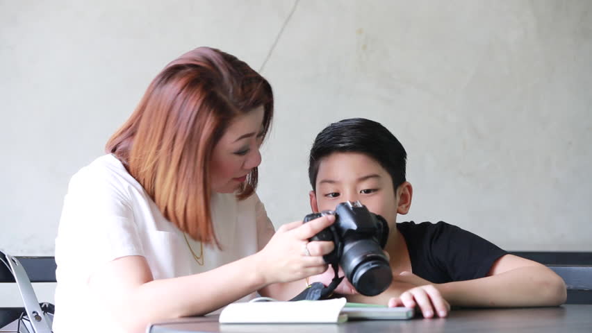 Asian Mother And Son Looking And Shoot With Dslr Camera