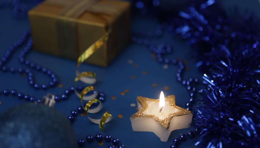 christmas candle over blue background stock footage video christmas candle over blue background stock footage video