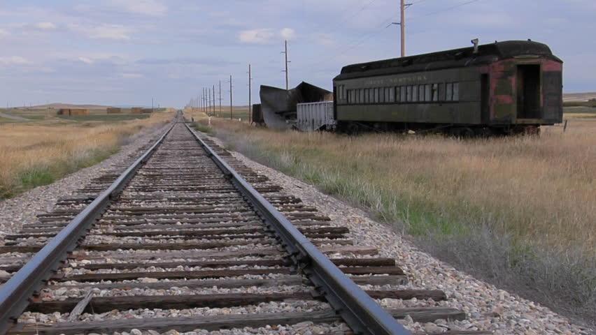 Railway Car Sits On A Siding Along A Lonely Stretch Of Railroad Track 