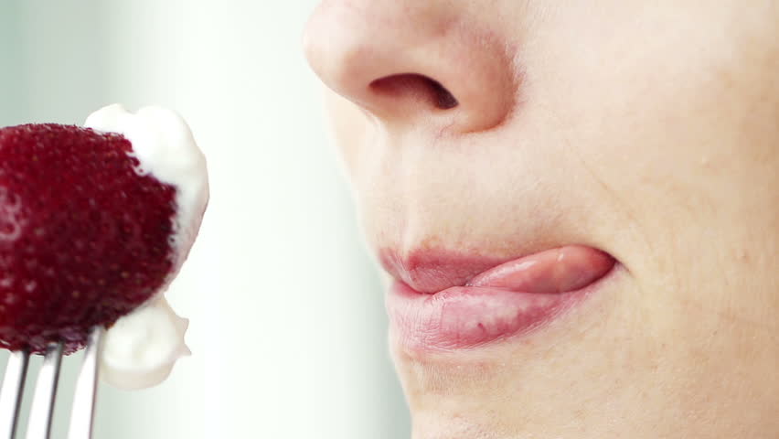 Woman Licking Lips In Front Of Strawberry Super Slow Motion Shot At