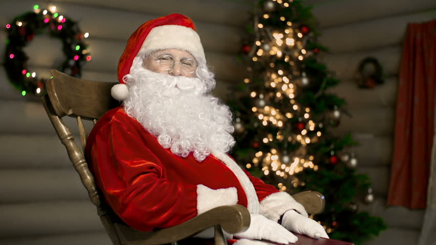 santa claus reading to himself in a rocking chair stock santa claus reading to himself in a rocking chair stock