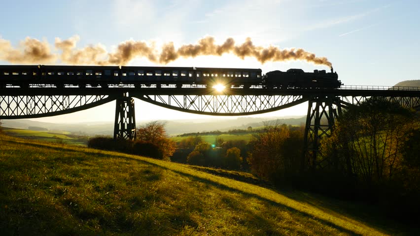 Epic Aerial View Of Steam Engine Train Crossing Bridge At Sunset Magic