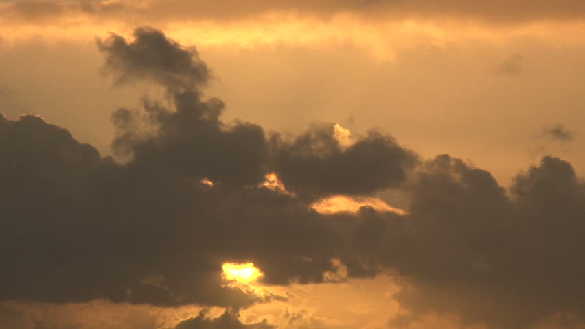 Sun Glowing Bright Against Dark, Cloudy Sky Time Lapse. Stock Footage