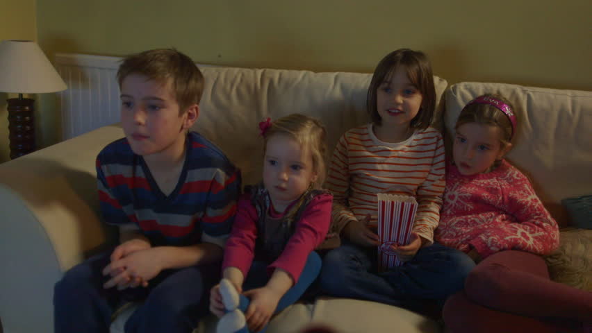 Sitting On Sofa And Popcorn Of Children Sitting On A Sofa And Popcorn