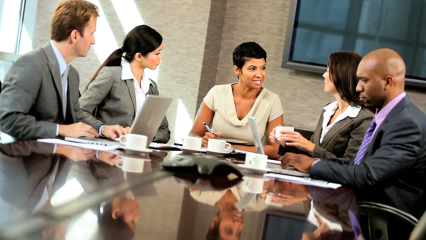 Female African American Executive In A Boardroom Meeting With Her Multi ...