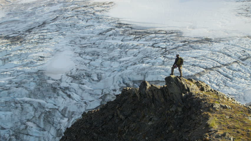aerial view of male mountain climber in summer enjoying success