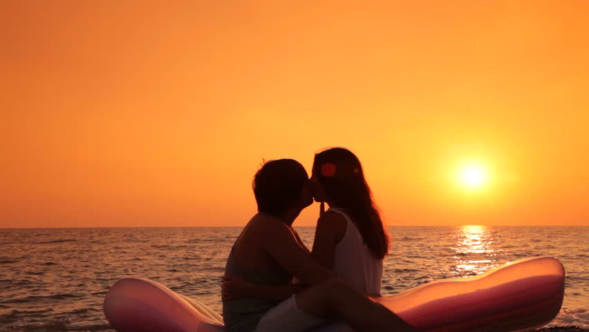 A Young Couple In Love On A Deserted Beach At Sunset Stock Footage ...