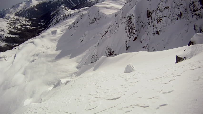 A Freestyle Skier Charges Down A Beautiful Snow Covered Mountain, Pov ...