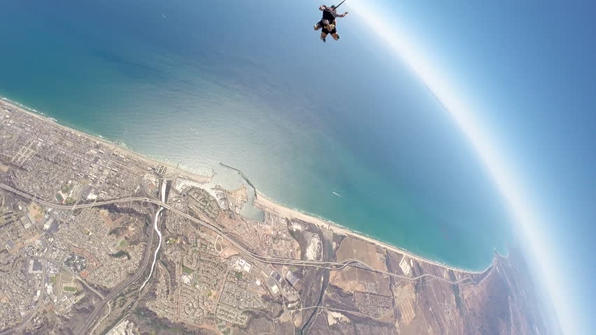 Two People Tandem Skydiving In The Sky With Clouds Visible Below, POV ...