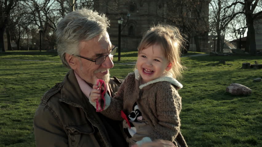 Grandfather Holding And Playing With Little Granddaughter. Old Man With ...